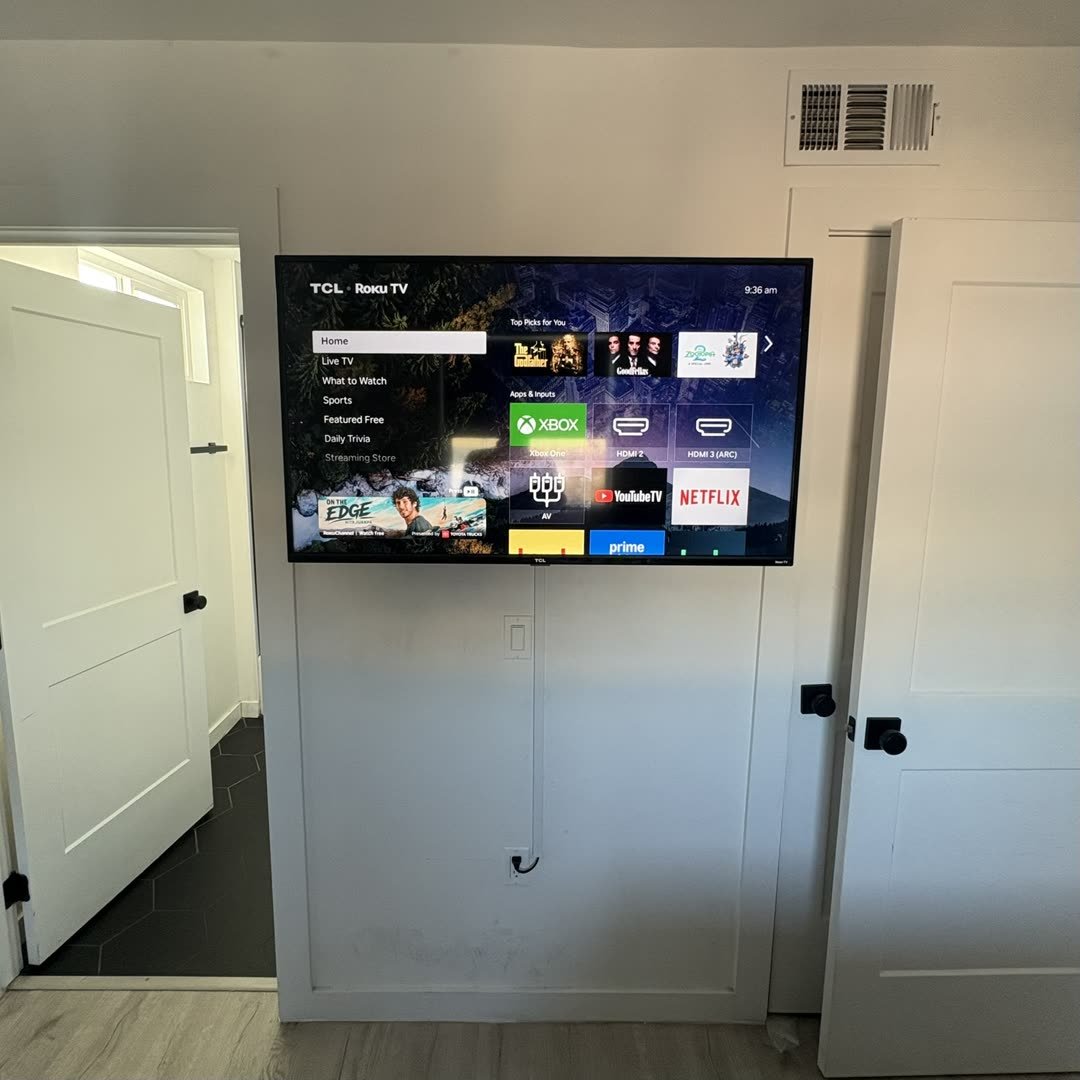 TCL Roku TV mounted between hallway doors