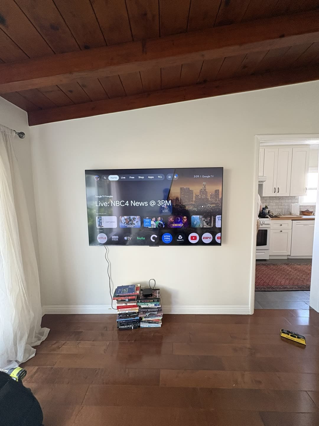 TCL Google TV mounted in wood ceiling room