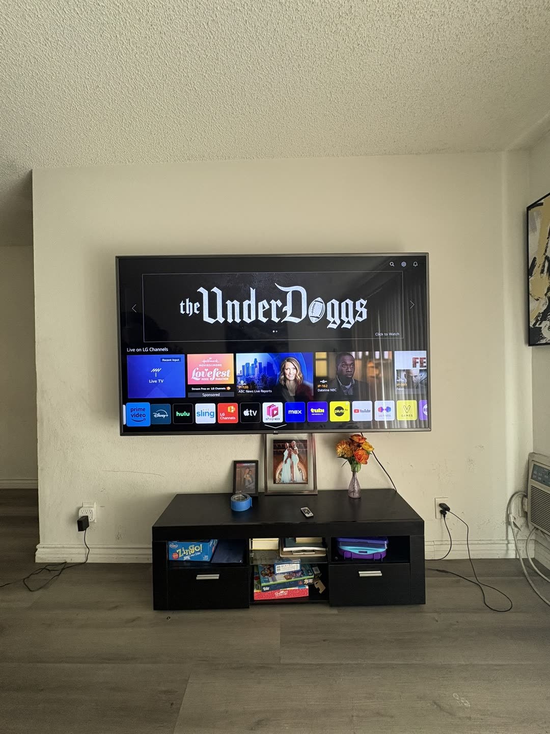 LG TV with soundbar mounted on living room wall