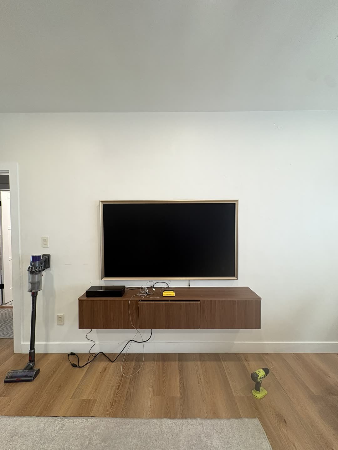 Samsung Frame TV above floating media console