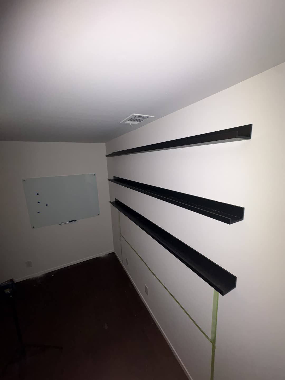 4 floating shelves installed on bedroom wall