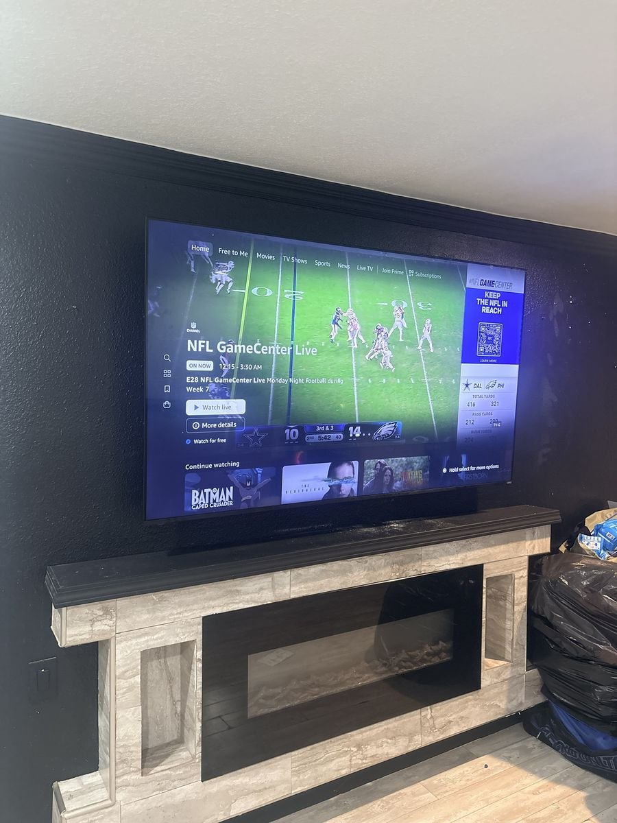 Side view of a TV mounted above a fireplace mantel